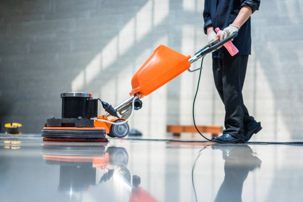 janitor making the floor shine using large electric mop