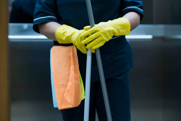 professional cleaner standing in elevator