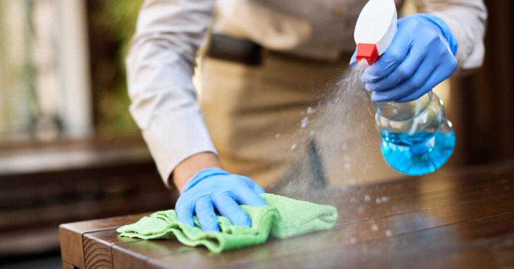 property management staff members, outfitted in cleaning gloves, are in the process of cleaning tables